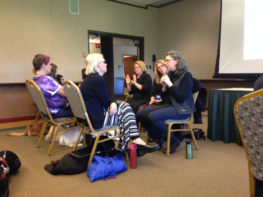 Guiding Eyes grads and interpreters attend a talk on how dogs' genetics influence their behavior.