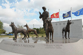 statues of 4 dogs and a soldier at the military dog national monument