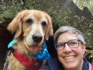 Golden retreiver Cali smiles as she poses next to Pam