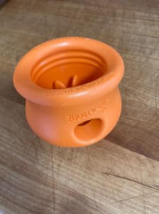 an orange cup-shaped Toppl toy