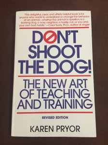 Book cover for Karen Pryor's Don't Shoot the Dog with blue type on a white background
